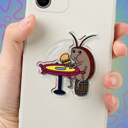 Roach Patty acrylic airbag phone grip, SpongeBob-inspired design of a roach eating a Krabby Patty, by Sticker Dam