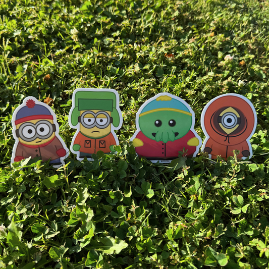 Minion South Park collection outside-shot showing all 4 stickers — Minion Stan, Kyle, Kenny, and Goomi Cartman — matte vinyl die-cut stickers by Sticker Dam